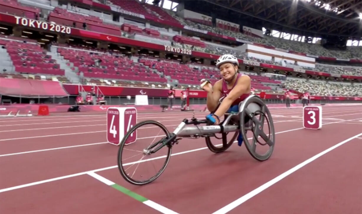Yen Hoang waves to the camera prior to her heat in the T53 800 meters at the Paralympic Games at Tokyo.