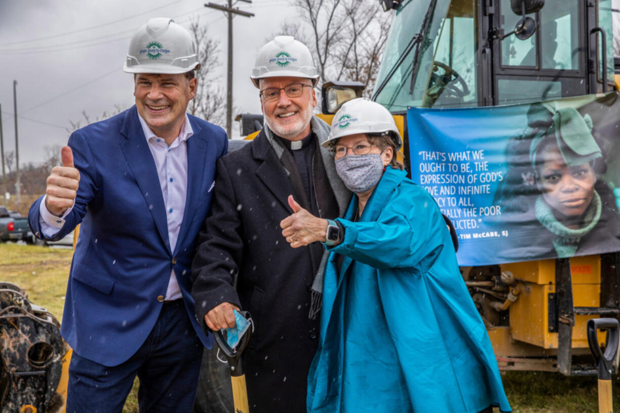 Ford CEO Jim Farley poses for a picture with Pope Francis Center executive director The Rev. Tim McCabe and Julia Burke Foundation board member Robbie Murphy after the groundbreaking ceremony Dec. 3 for Pope Francis Center's New Bridge Housing Campus to end chronic homelessness in Detroit . (Kimberly P.