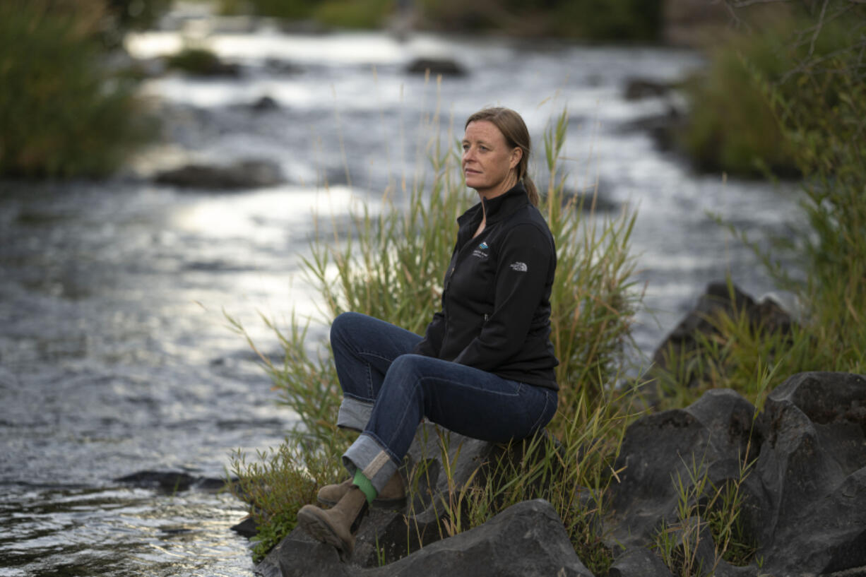 Kate Fitzpatrick, the executive director of the Deschutes River Conservancy, poses for a press photo along the banks of the middle Deschutes River on Tuesday, Aug. 31, 2021, in Bend, Ore. "We're trying to figure out ways for water to move around more flexibly," she said.