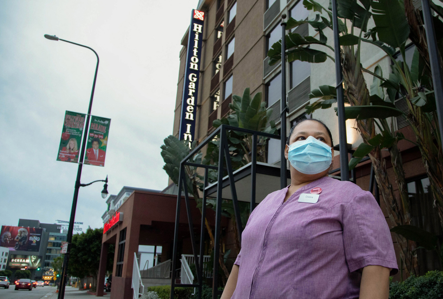 Cristina Velasquez, a housekeeper at Hilton Garden Inn in Los Angeles seen here on Tuesday, Dec. 21, 2021, says since the pandemic, she has to clean three to four days worth of trash, dirty linens and towels in the same amount of time as before. (Myung J.