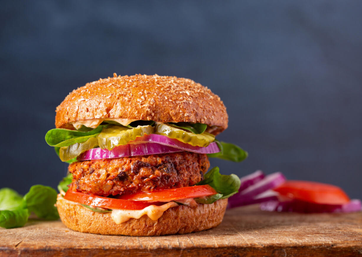 Homemade plant based burger made from sweet potato, black beans and brown rice on a whole wheat brioche bun; copy space (iStock.com)