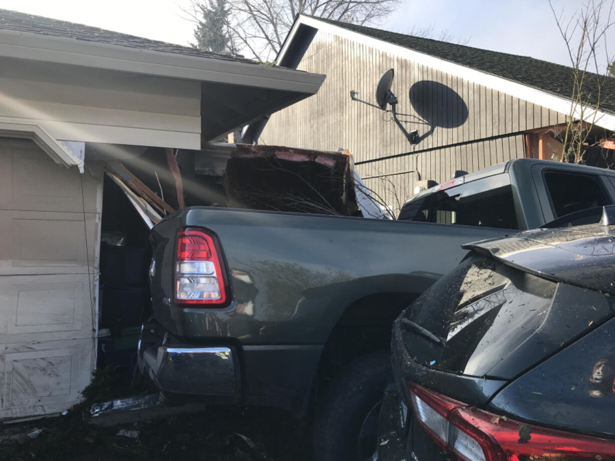 A green pickup truck crashed into a house and parked car in the 14100 block of Southeast McGillivray Boulevard after driving erratically through the east Vancouver neighborhood Monday morning. The driver of the pickup will be booked into the Clark County Jail on suspicion of DUI and multiple counts of hit and run, according to the Vancouver Police Department.