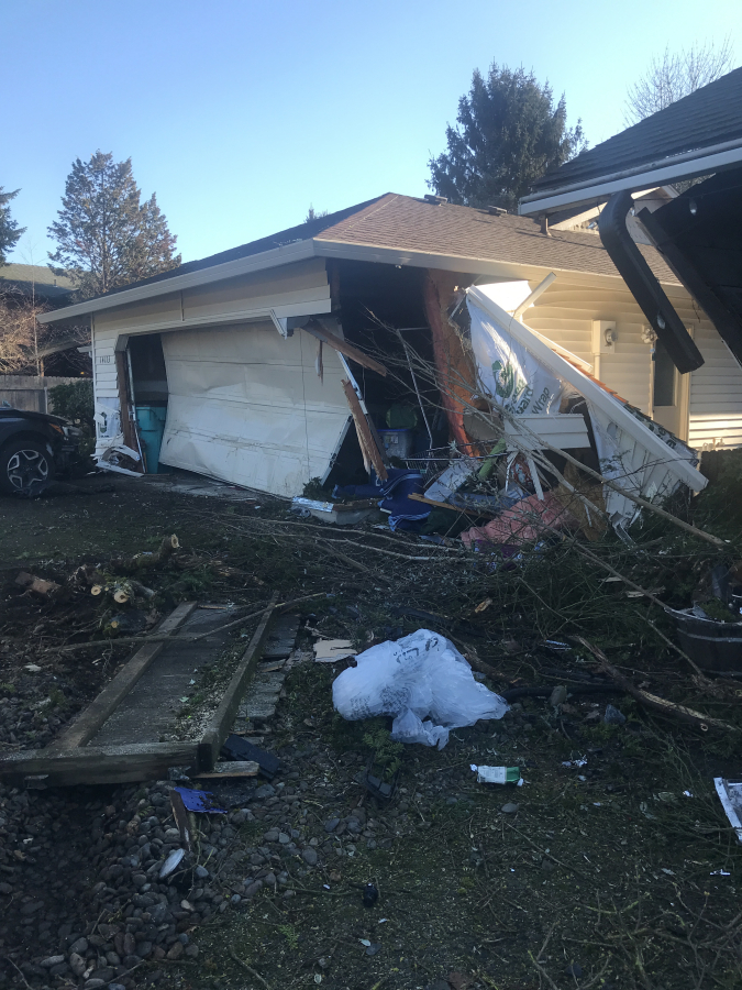 The garage of a house in the 14100 block of Southeast McGillivray Boulevard was destroyed after a driver who police say was impaired and speeding crashed into it Monday morning. Some pedestrians reported narrowly avoiding being hit by the driver before he crashed.