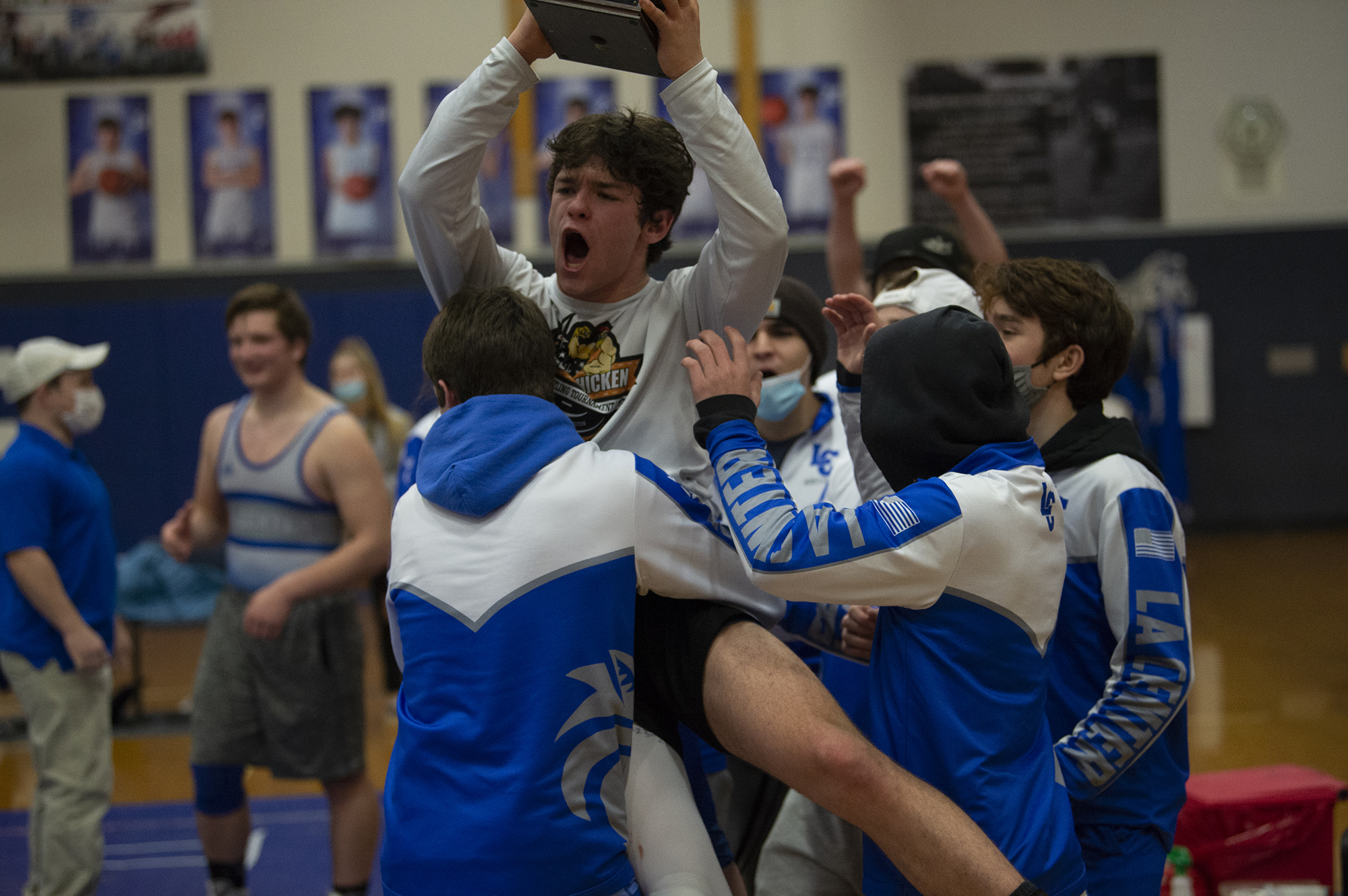 La Center's Austin Mattson is hoisted by his teammate as he holds the SpudCat Trophy, awarded to the winner of  the Ridgefield-La Center wrestling match. La Center beat Ridgefield 35-30 on Thursday night La Center on a pin by Leah Wallway at 106 pounds.