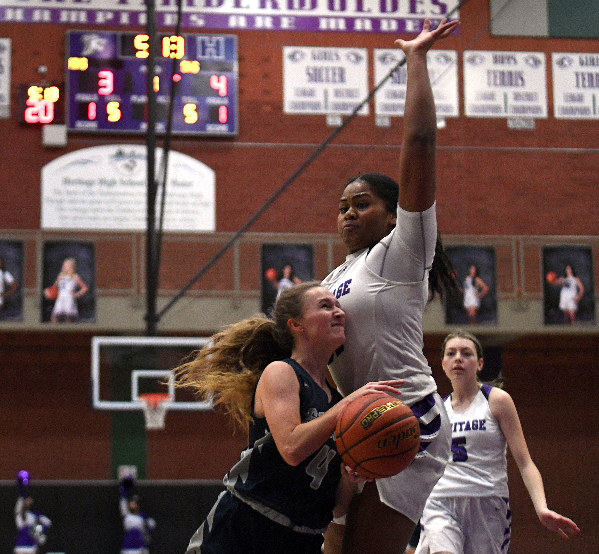 Skyview sophomore Samantha Groesbeck looks to shoot the ball under pressure from Herigage junior Keanna Salavea on Tuesday, Jan. 4, 2022, during the Storm’s 66-40 win against the Timberwolves at Heritage High School.