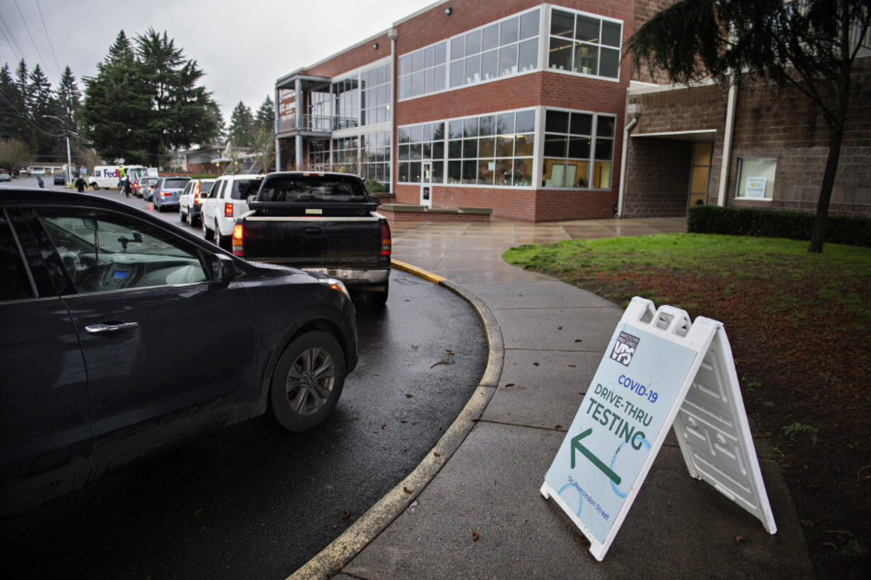 A line of students and faculty from Vancouver Public Schools gather outside the Jim Parsley Center for free drive-thru COVID-19 screening Thursday afternoon.