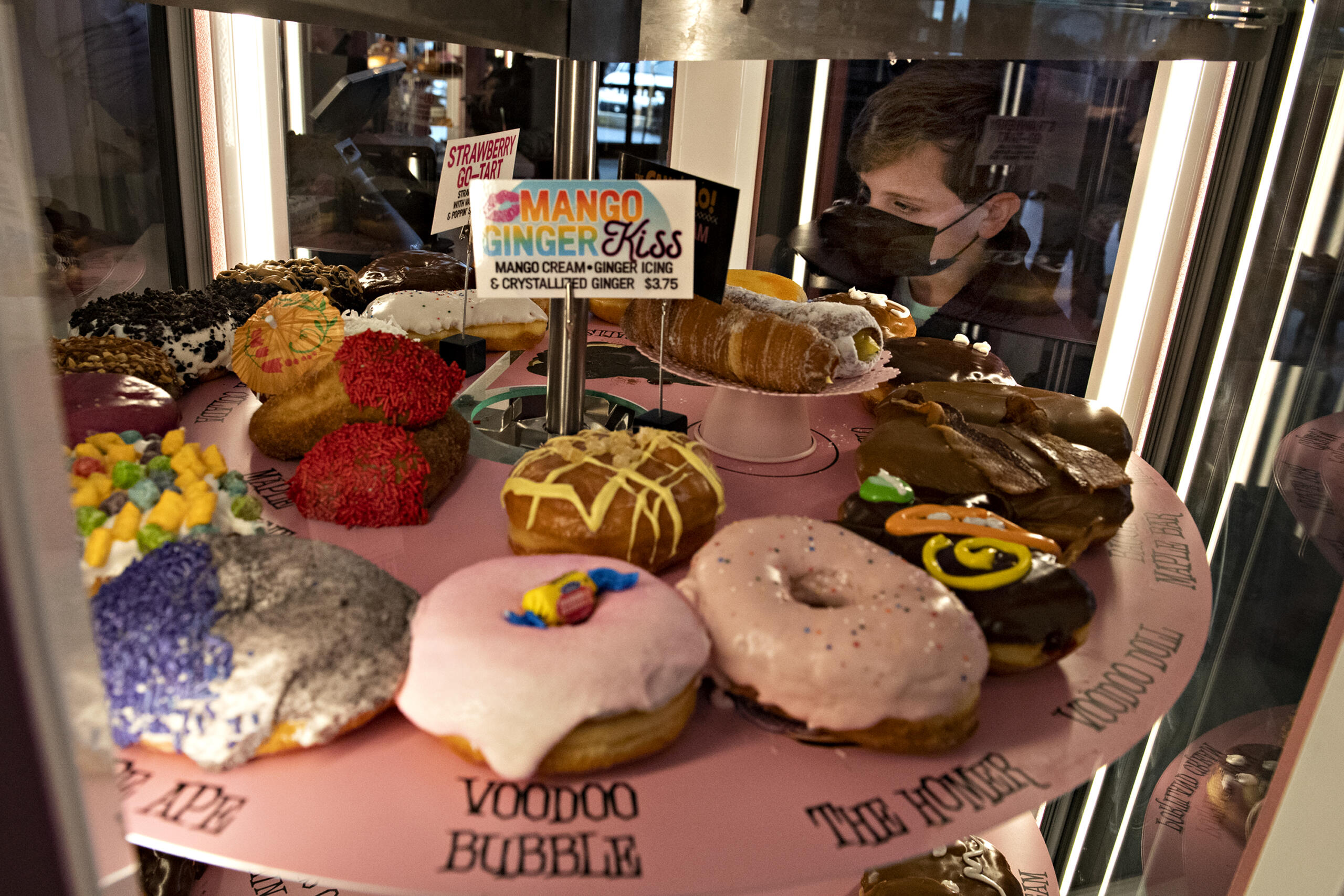 Ridgefield resident James Tobin, 8, tries to decide which doughnut to get while looking over the selection at the new Voodoo Doughnut at Vancouver Mall on Tuesday morning, Jan.11, 2022.