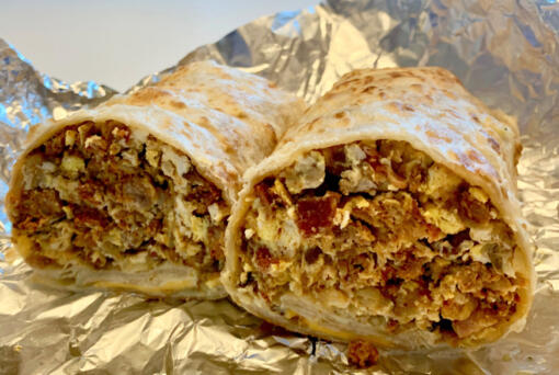 Delicious Tacos' breakfast burrito ($9) comes with eggs, chorizo, ham, sausage, hash browns, bacon, sour cream and cheese rolled in a generous but not overwhelming portion. (Rachel Pinsky)