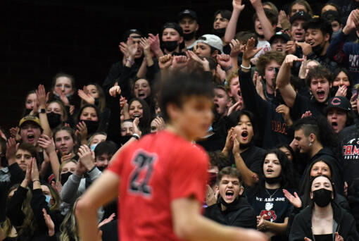 Camas students celebrate a basket Wednesday, Jan. 12, 2022, during the Papermakers’ 72-60 loss to the Titans at Union High School.  (Taylor Balkom/The Columbian)