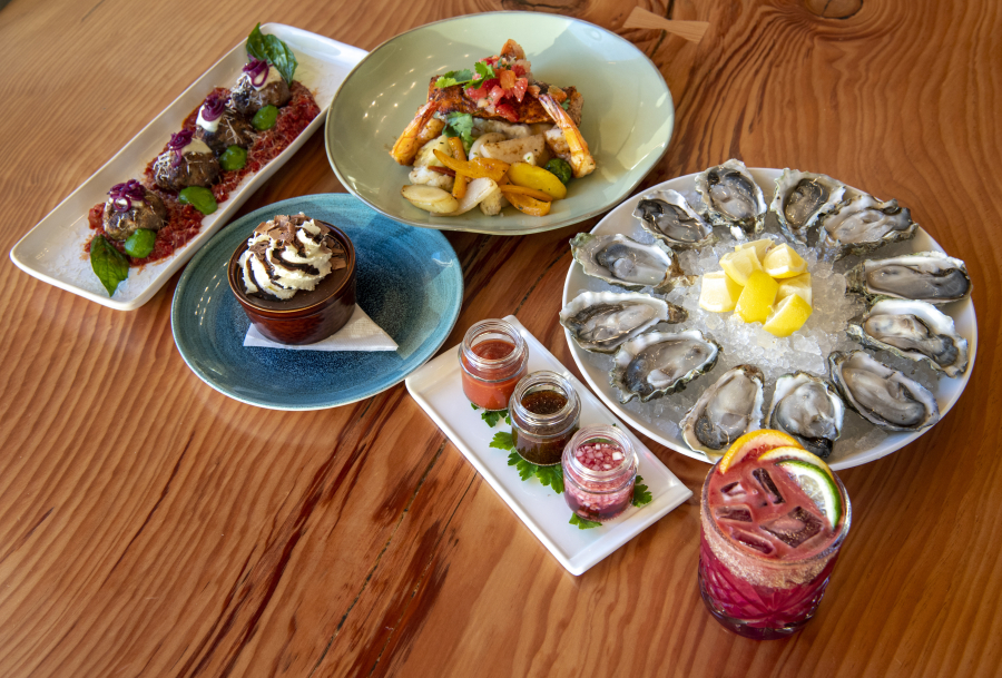 The Cove serves seafood and other dishes. Clockwise from top left are the meatball appetizer; Ora King salmon and prawns; Luna Bella oysters with side sauces; blood orange margarita; chocolate peanut butter pot de creme.