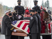 Pallbearers move the casket of retired Clark County Fire District 6 firefighter-paramedic Joe Killian off an antique fire engine Tuesday before his funeral service at the Liberty Bible Church of the Nazarene. Killian, 56, died from multiple myeloma, a cancer common among firefighters.