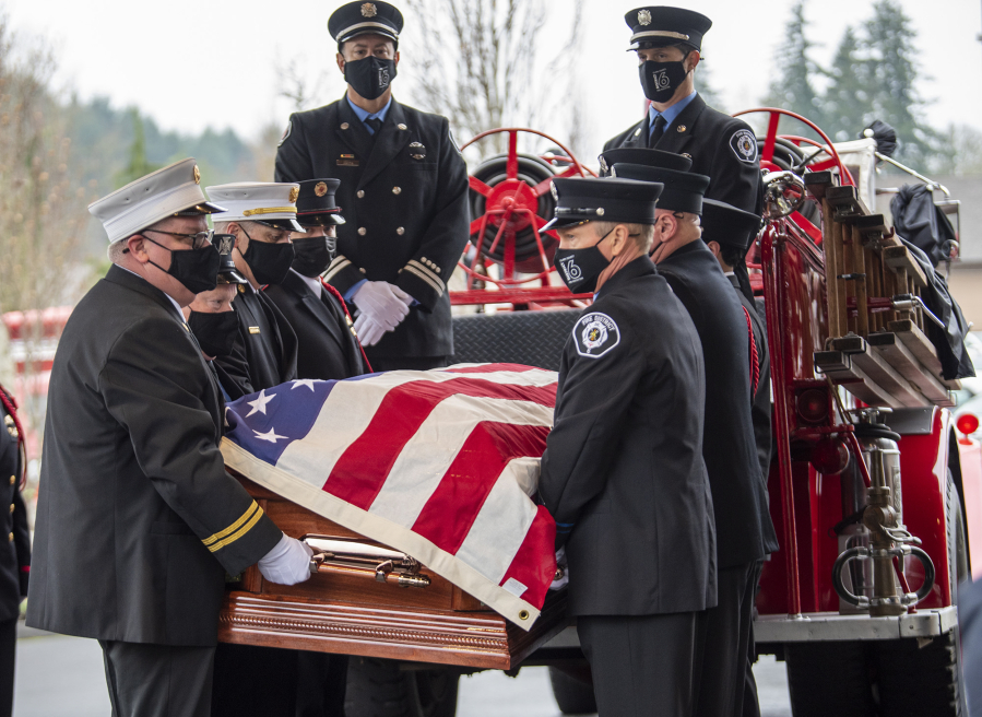 Pallbearers move the casket of retired Clark County Fire District 6 firefighter-paramedic Joe Killian off an antique fire engine Tuesday before his funeral service at the Liberty Bible Church of the Nazarene. Killian, 56, died from multiple myeloma, a cancer common among firefighters.