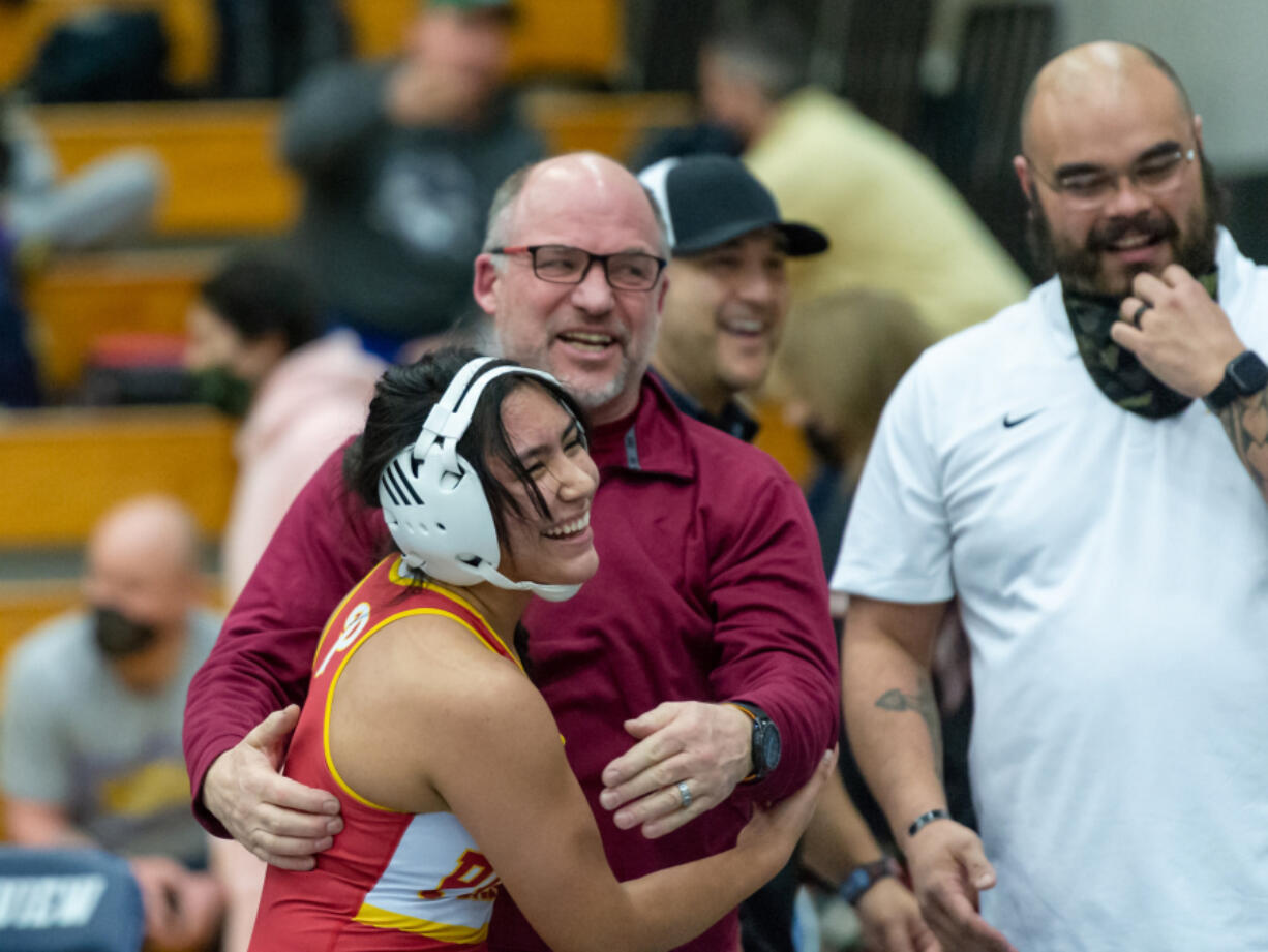 Prairie's Yana Paskar hugs coach Rob Smith after securing the Falcons a team title with a pin in the 145-pound finals at the Norm Friehauf Clark County Championships on Saturday at Skyview High School.