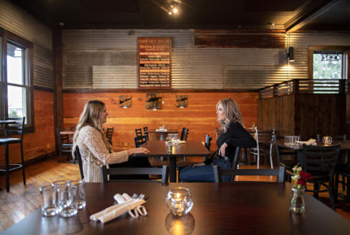Devin McFeron of Desert Society, left, chats with Emma Fraser of Farrar's Bistro inside Farrar's Bistro in Felida. Both business owners are just in their 20s, and they encourage other young adults to take a chance on their career dreams.