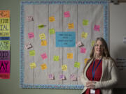 Lillie Shaver, a social-emotional learning center clerk at Chief Umtuch Middle School in Battle Ground, is surrounded by inspirational messages in the school's Wolverine Den on Friday morning. The program is a part of a districtwide effort to provide social-emotional support to students acting out in class in place of punishment or an interruption of learning.