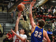 Camas senior Carson Frawley, left, shoots the ball Friday, Jan. 21, 2022, during the Papermakers??? 83-38 win against the Hilanders at Camas High School.