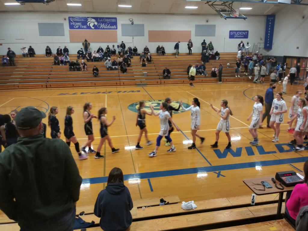 La Center and Seton Catholic plays slap hands after La Center's 64-34 win over Seton in a Trico League girls basketball game.