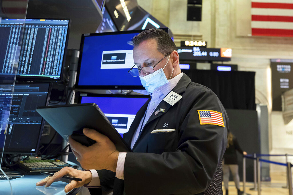 In this photo provided by the New York Stock Exchange, trader Edward Curran works on the floor, Monday, Jan. 24, 2022. The Dow Jones Industrial Average dropped more than 1,000 points Monday as financial markets buckled in anticipation of inflation-fighting measures from the Federal Reserve and fretted over the possibility of conflict between Russia and Ukraine.