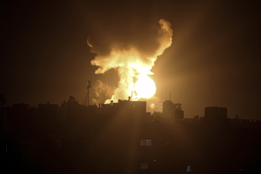 An explosion caused by Israeli airstrikes is seen in the town of Khan Younis, southern Gaza Strip, Sunday Jan, 2, 2022. Israel's military says it launched strikes against militant targets in the Gaza Strip, a day after rockets were fired from the Hamas-ruled territory.