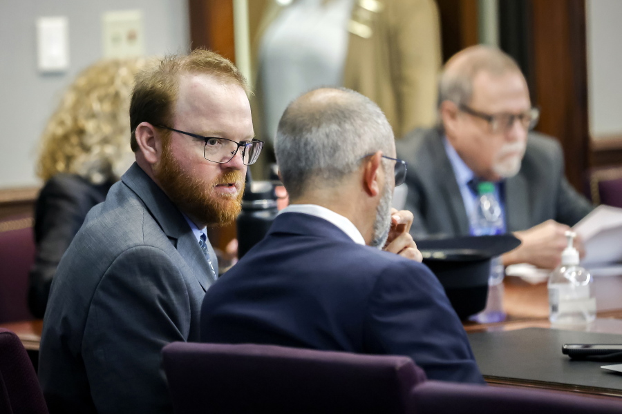 Travis McMichael, left, speaks with his attorney Jason B. Sheffield , center, during his sentencing, alone with his father Greg McMichael and neighbor, William "Roddie" Bryan in the Glynn County Courthouse, Friday, Dec. 7, 2022, in Brunswick, Ga. The three found guilty in the February 2020 slaying of 25-year-old Ahmaud Arbery. (AP Photo/Stephen B.