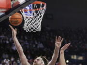 Gonzaga forward Drew Timme, left, shoots in front of BYU forward Caleb Lohner during the first half of an NCAA college basketball game, Thursday, Jan. 13, 2022, in Spokane, Wash.