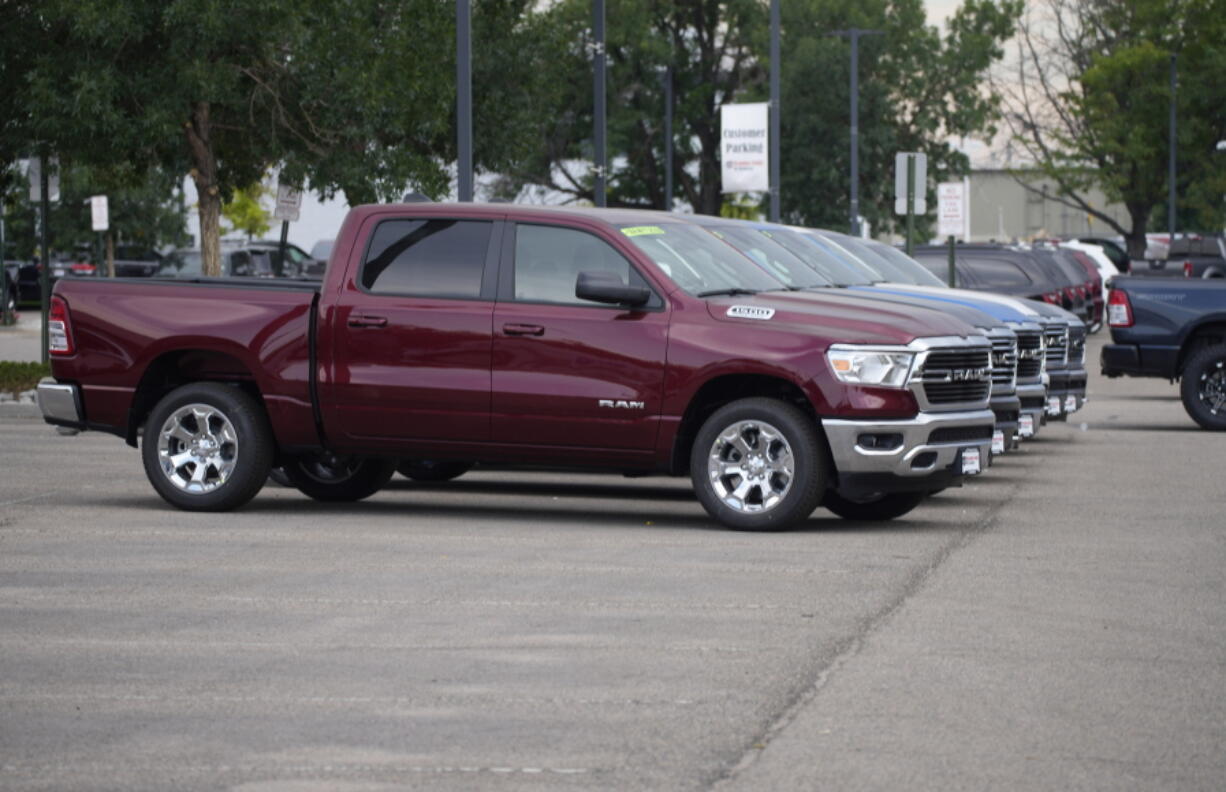 Only a handful of unsold 2021 Ram pickup trucks sit on the empty storage lot outside a Ram dealership on Aug. 29 in Littleton, Colo.