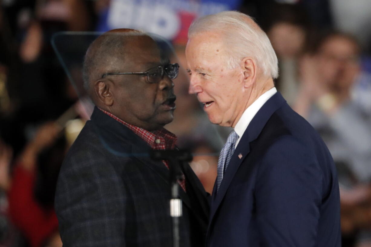 Then-Democratic presidential candidate Joe Biden talks to Rep. James Clyburn, D-S.C., at a primary night election rally in Columbia, S.C., Feb. 29, 2020 after winning the South Carolina primary. President Biden has frequently referenced the critical role South Carolina played in his nomination. He points to his decades-long relationship with the state whose Black voters handed him a major win at a desperate time for his Democratic campaign. But, in recent interviews with The Associated Press, some Black voters in South Carolina who supported Biden reluctantly -- or not at all -- say they're unimpressed and even dispirited.