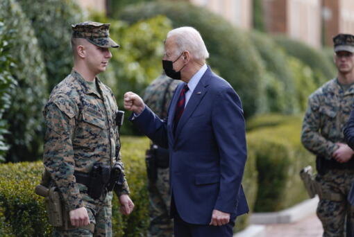 President Joe Biden visits a marine outside the Marine Barracks Washington, Tuesday, Jan. 25, 2022, in Washington.