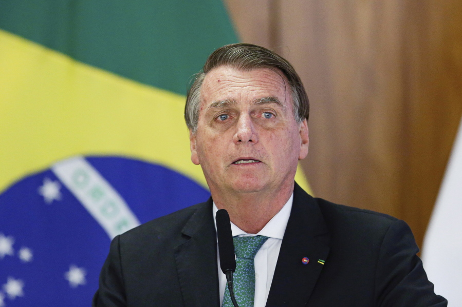 Press members gather outside Vila Nova Star hospital where Brazilian President Jair Bolsonaro is hospitalized in Sao Paulo, Brazil, Monday, Jan. 3, 2022. Bolsonaro is at the hospital Monday for tests after experiencing abdominal discomfort and is in stable condition, according to a hospital statement.