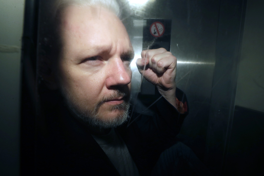 FILE - WikiLeaks founder Julian Assange being taken from court, where he appeared on charges of jumping British bail seven years ago, in London, Wednesday May 1, 2019. Britain's High Court is set to rule on whether WikiLeaks founder Julian Assange can take his fight against U.S. extradition to the U.K. Supreme Court. The decision is the latest step in Assange's long battle to avoid being sent to the United States to face espionage charges over WikiLeaks' publication of classified documents.