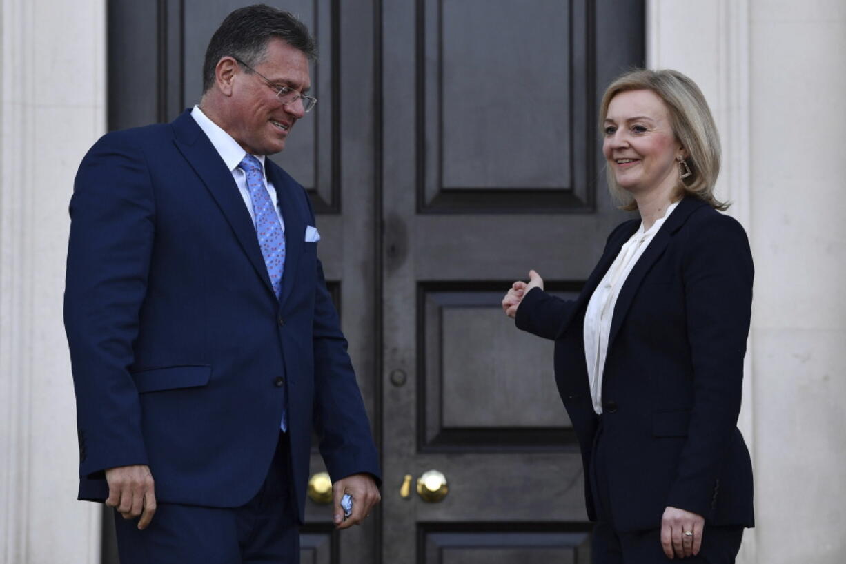 Foreign Secretary Liz Truss, left, greets EU post-Brexit negotiator Maros Sefcovic as he arrives for a meeting at Chevening in Kent, England, Thursday, Jan. 13, 2022. Top negotiators from Britain and the European Union are meeting in hope of resolving their a thorny dispute over Northern Ireland trade.