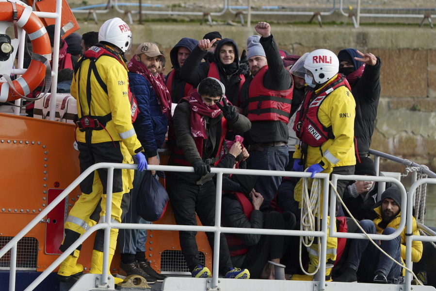 A group of people thought to be migrants are brought in to Dover, Kent, Britain, by the RNLI following a small boat incident in the Channel, Tuesday Jan. 4, 2022. At least 28,300 people packed into small boats crossed the Channel from France to England's south coast in 2021, an annual record that was three times the number of crossings a year earlier. The leap in numbers, reported by the Press Association news agency based on data from Britain's Home Office, reflects the soaring number of migrants seeking to cross the world's busiest shipping lane often in flimsy boats provided by people smugglers.