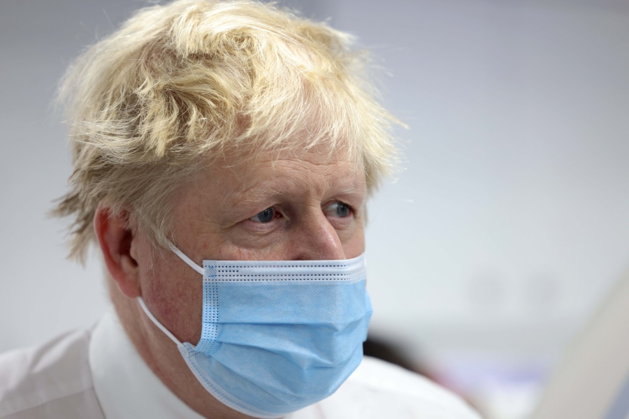 Britain's Prime Minister Boris Johnson looks on during a visit to Finchley Memorial Hospital, in North London, Tuesday, Jan. 18, 2022.