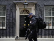 A police officer walks past 10 Downing Street in London, Tuesday, Jan. 25, 2022. London police say they are now investigating Downing Street parties during lockdown. Metropolitan Police Commissioner Cressida Dick revealed an investigation was underway in a statement before the London Assembly on Tuesday. Dick said Scotland Yard is now investigating "a number of events" at Downing Street.