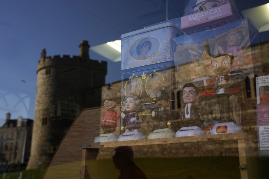 Souvenirs are displayed for sale in the window of a shop with a reflection of Windsor Castle, in Windsor, England, where Prince Andrew residence is nearby in the grounds of Windsor Great Park, Thursday, Jan. 13, 2022. A judge has -- for now -- refused to dismiss a lawsuit against Britain's Prince Andrew by an American woman who says he sexually abused her when she was 17. Stressing Wednesday that he wasn't ruling on the truth of the allegations, U.S. District Judge Lewis A. Kaplan rejected an argument by Andrew's lawyers that Virginia Giuffre's lawsuit should be thrown out at an early stage because of an old legal settlement she had with Jeffrey Epstein, the financier she claims set up sexual encounters with the prince.
