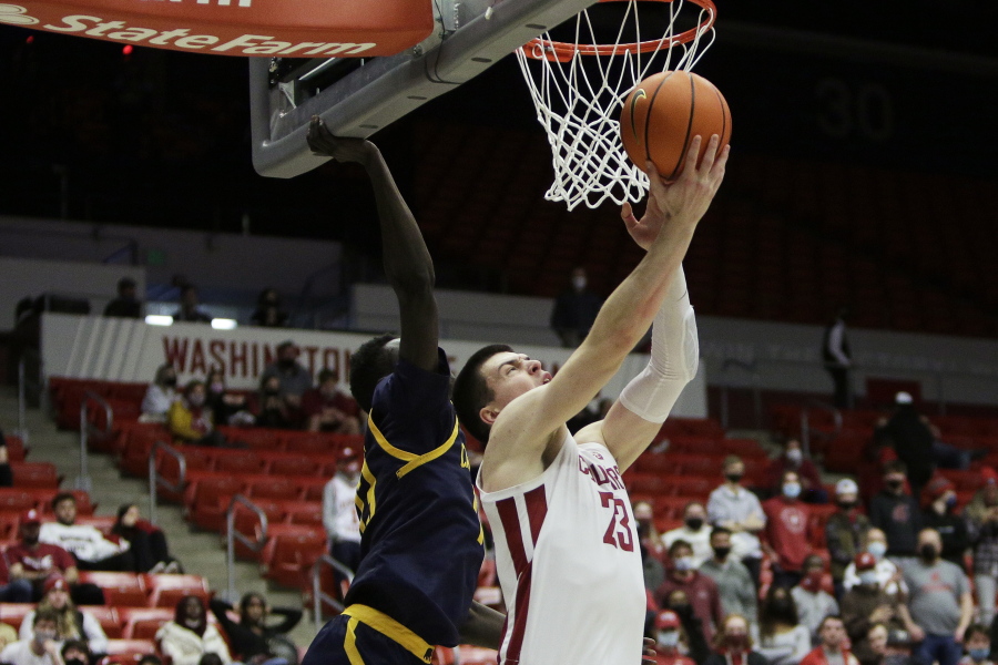 Washington State forward Andrej Jakimovski, right, shoots in front of California forward Kuany Kuany during the second half of an NCAA college basketball game, Saturday, Jan. 15, 2022, in Pullman, Wash.