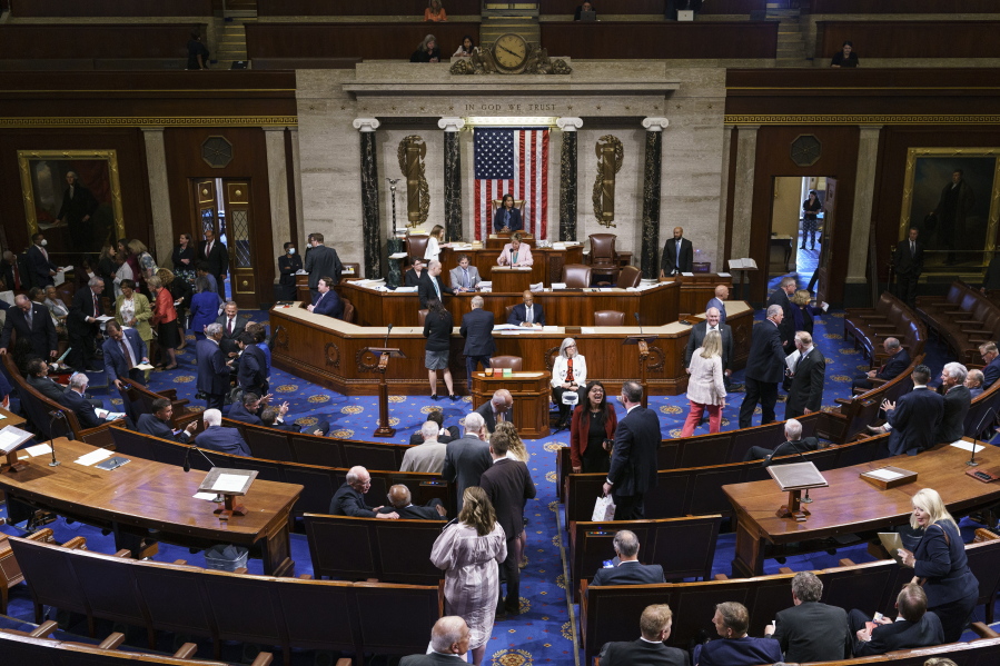 FILE - Members of the House of Representatives gather in the chamber to vote on creation of a select committee to investigate the Jan. 6 Capitol insurrection, at the Capitol in Washington, on June 30, 2021. (AP Photo/J.