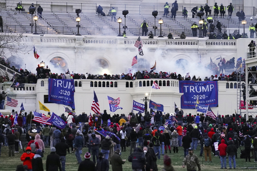 FILE - Violent protesters, loyal to President Donald Trump, storm the Capitol in Washington on  Jan. 6, 2021.  Federal authorities say a man charged this week with storming the U.S. Capitol performed rap songs about the riot in videos posted on his YouTube channel. A relative told the FBI that Billy Knutson was a rapper who sold his music online and had posted on social media that he was at the Capitol on Jan. 6, 2021. The FBI says a surveillance video showed Knutson enter the Capitol by climbing through a broken window.