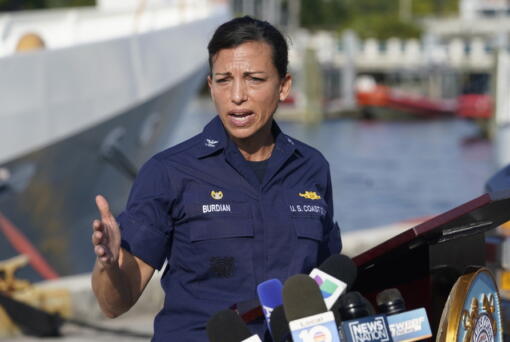 U.S. Coast Guard Captain Jo-Ann F. Burdian details the search of 38 missing migrants at a news conference, Wednesday, Jan. 26, 2022, in Miami Beach, Fla. One migrant was found clinging to the hull of an overturn vessel and one body was recovered off the coast of Fort Pierce, Fla. The migrants left the Bahamas on Saturday in what the Coast Guard suspects is a human smuggling operation.