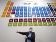 TerraPower's Michael Anderson, manager of test engineers and technicians, talks about the large periodic table on the wall overhead during a tour of the nuclear reactor development facility, Thursday, Jan. 13, 2022, in Everett, Wash. TerraPower plans to make its plant useful for today's energy grid with ever more renewable power. A salt heat "battery" will allow a nuclear plant to ramp up electricity production on demand, offsetting dips in electricity when the wind isn't blowing and sun isn't shining.