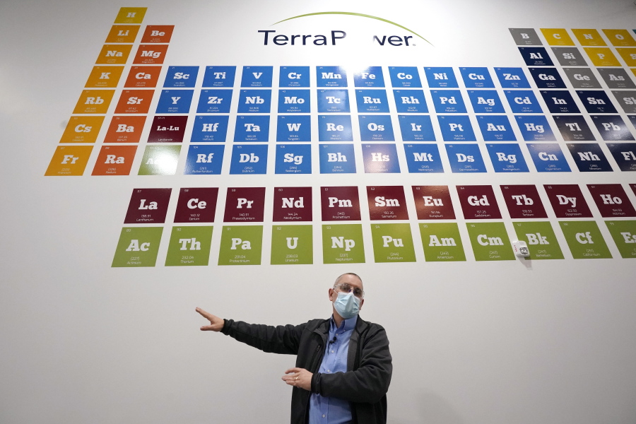 TerraPower's Michael Anderson, manager of test engineers and technicians, talks about the large periodic table on the wall overhead during a tour of the nuclear reactor development facility, Thursday, Jan. 13, 2022, in Everett, Wash. TerraPower plans to make its plant useful for today's energy grid with ever more renewable power. A salt heat "battery" will allow a nuclear plant to ramp up electricity production on demand, offsetting dips in electricity when the wind isn't blowing and sun isn't shining.