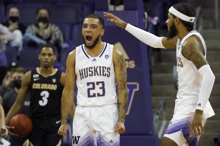 Washington guard Terrell Brown Jr. (23) reacts with guard PJ Fuller, right, after making a basket against Colorado during the second half of an NCAA college basketball game, Thursday, Jan. 27, 2022, in Seattle. Washington won 60-58. (AP Photo/Ted S.