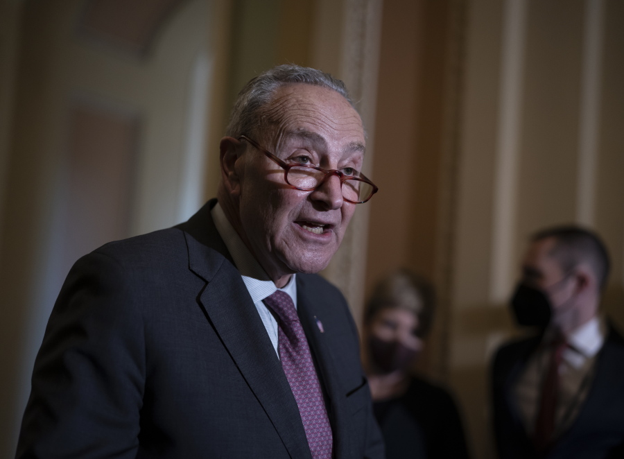 Senate Majority Leader Chuck Schumer, D-N.Y., speaks to reporters after a Democratic policy meeting at the Capitol in Washington, Tuesday, Dec. 14, 2021. (AP Photo/J.
