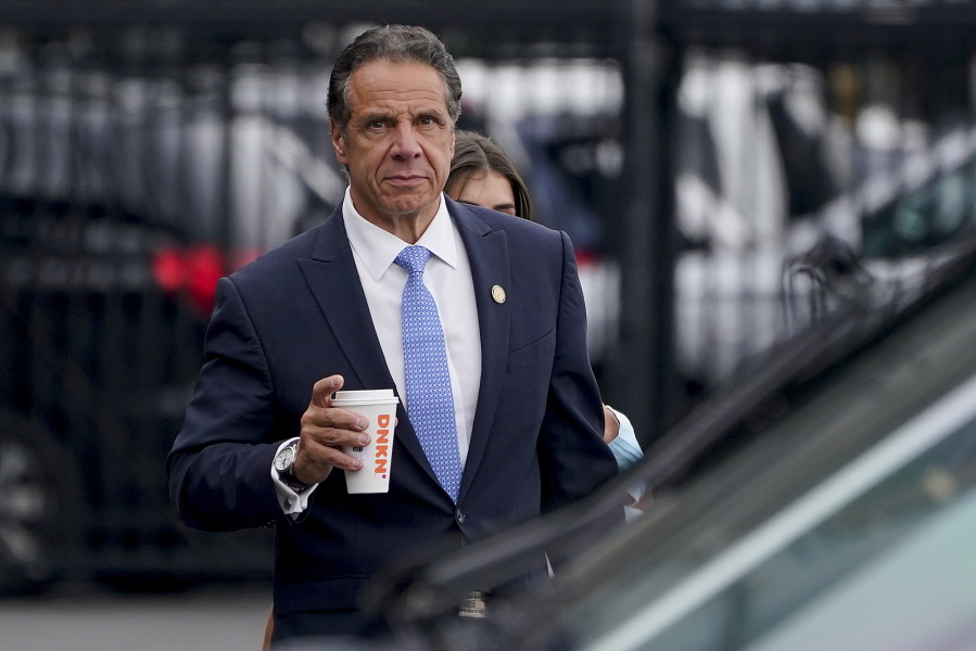 FILE - New York Gov. Andrew Cuomo prepares to board a helicopter after announcing his resignation, Aug. 10, 2021, in New York. Albany's top prosecutor said Tuesday, Jan. 4, 2022, he is dropping a criminal charge accusing former New York Gov. Andrew Cuomo of fondling an aide.
