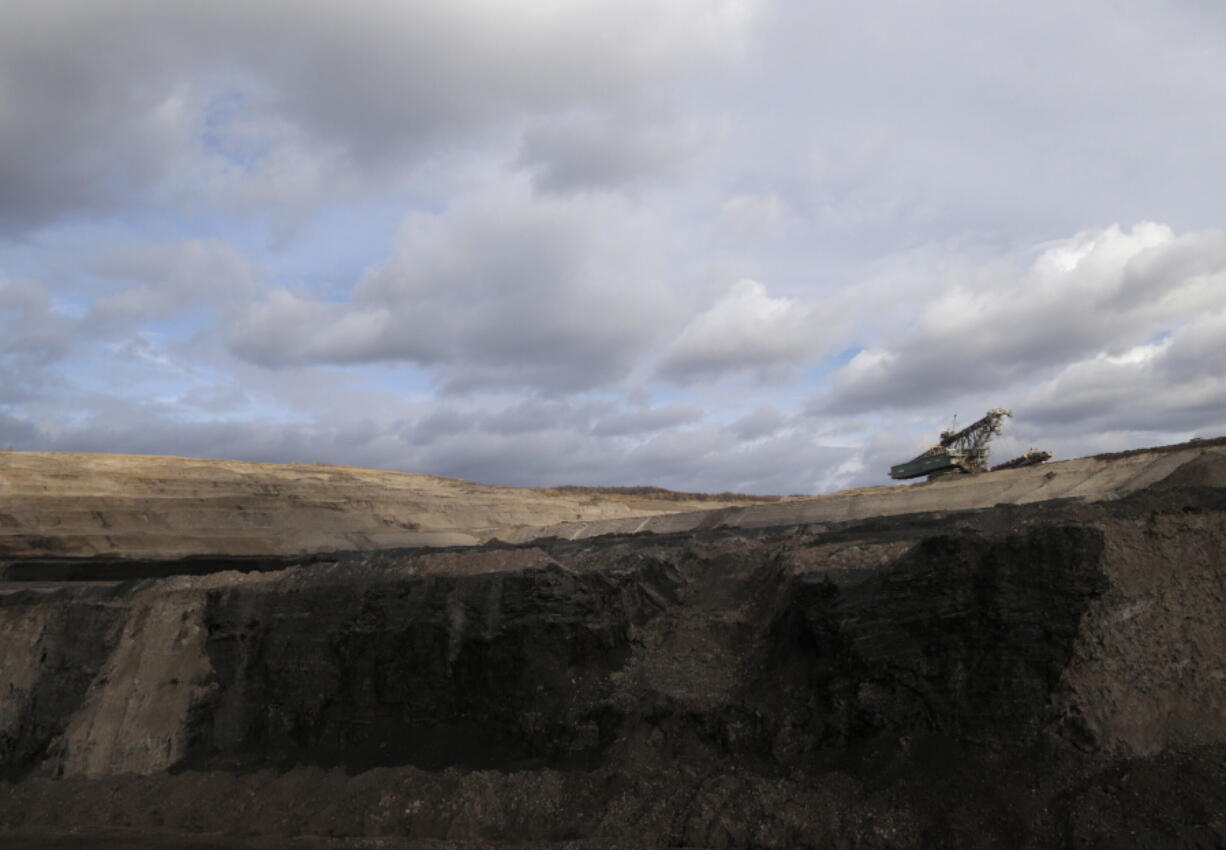File - In this file photo taken on Thursday, Nov. 12, 2015 near the town of Most, Czech Republic, a huge excavator stands inside a giant open pit lignite mine. On Friday Jan. 7, 2022, the new Czech government pledged to work for the country to be able to phase out coal as an energy source by 2033.