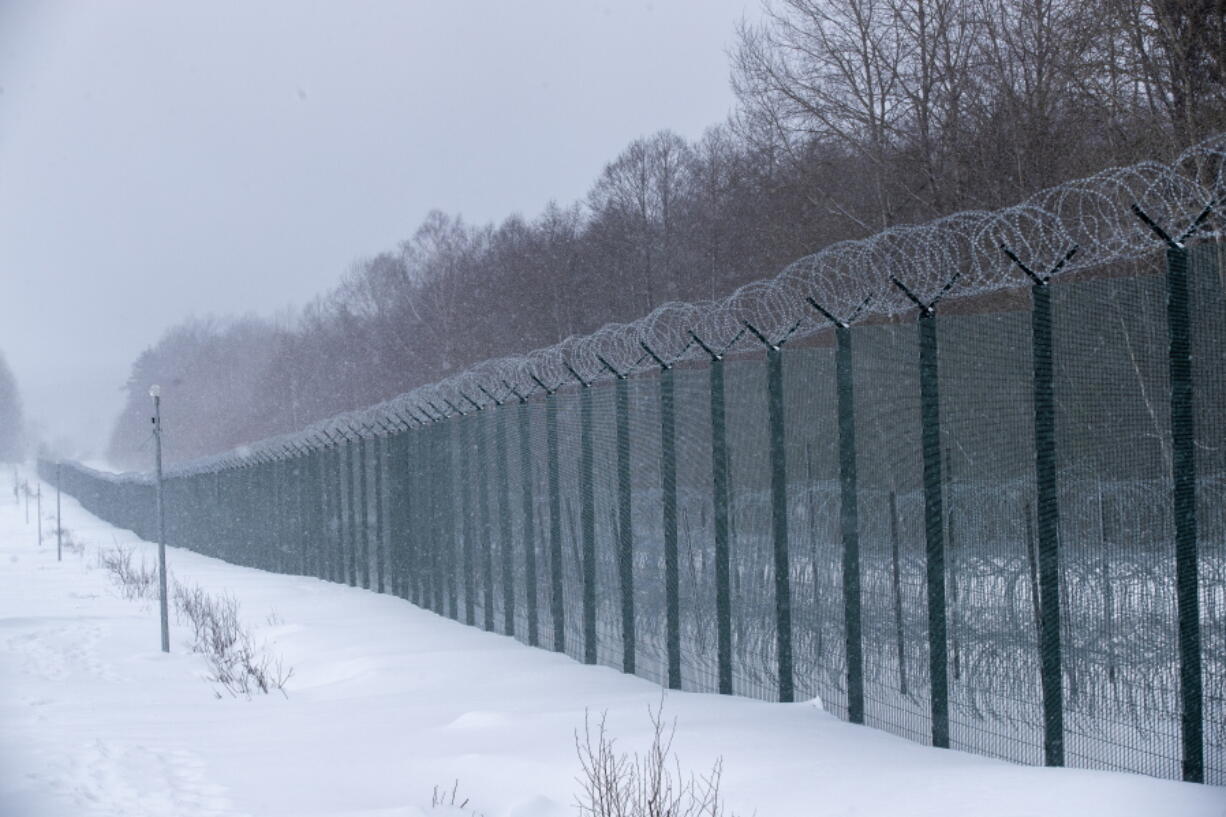 A view of the four-meter-high fence on the Lithuanian-Belarusian border during a visit by participants of the Conference on Border Management near the village Kurmelionys, some 40km (24 miles) east of the capital Vilnius, Lithuania, Friday, Jan. 21, 2022.