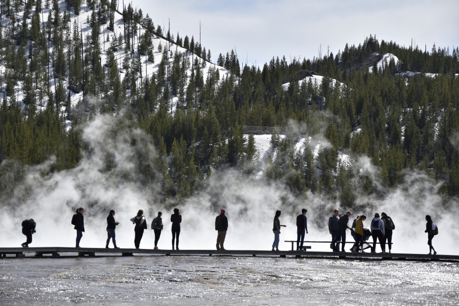 FILE - Visitors are seen at Grand Prismatic Spring in Yellowstone National Park, Wyo. on May 1, 2021. Yellowstone Superintendent Cam Sholly says officials want wants to use the park's 150th anniversary this year to recognize the many American Indian nations that lived in the area for thousands of years before the park was created.