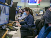 Traders work on the New York Stock Exchange floor in New York, Tuesday, Jan. 25, 2022. Stocks are closing lower on Wall Street Tuesday after another volatile day of trading. Technology companies like Microsoft were again the biggest drag on the market.