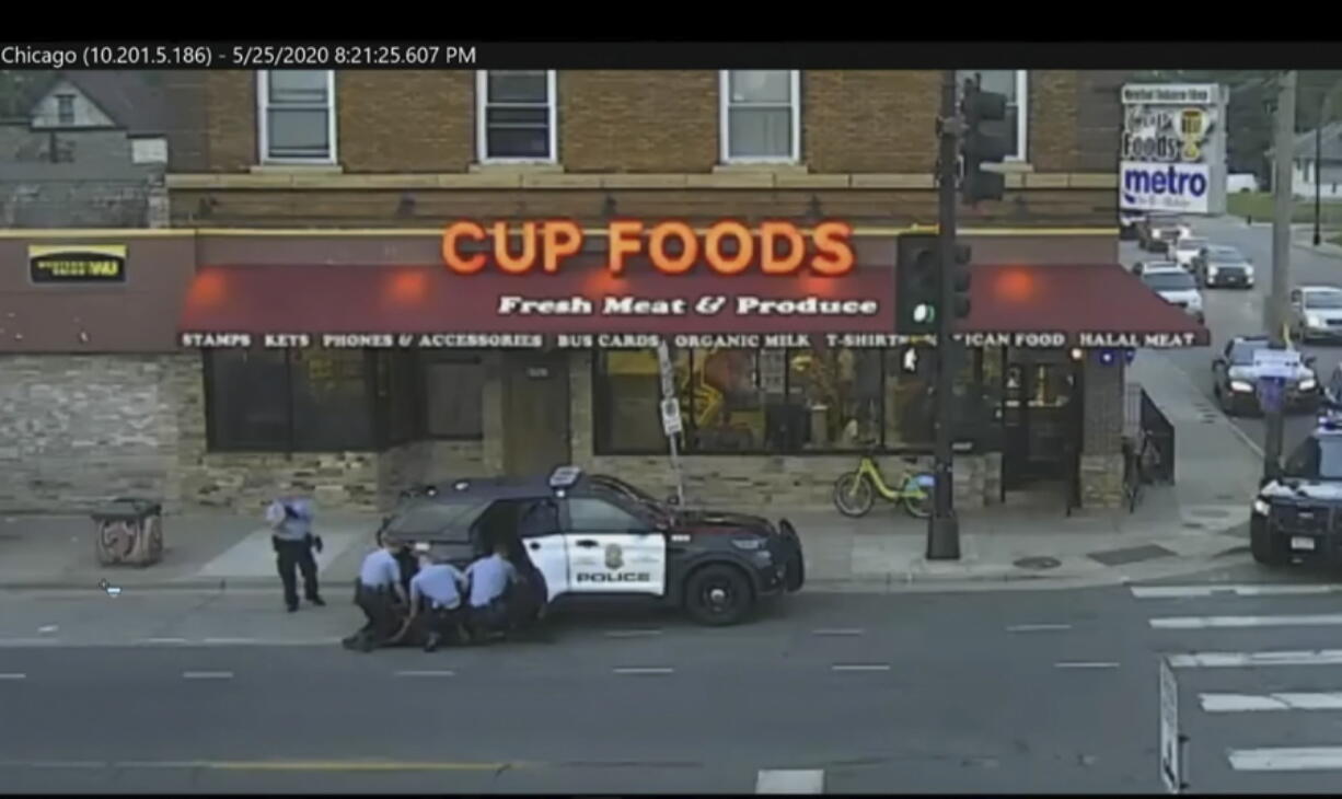 FILE - In this image from surveillance video, Minneapolis police Officers from left, Tou Thao, Derek Chauvin, J. Alexander Kueng and Thomas Lane are seen attempting to take George Floyd into custody in Minneapolis, Minn on May 25, 2020. Three former Minneapolis officers headed to trial this week on federal civil rights charges in the death of George Floyd aren't as familiar to most people as Chauvin, a fellow officer who was convicted of murder last spring.