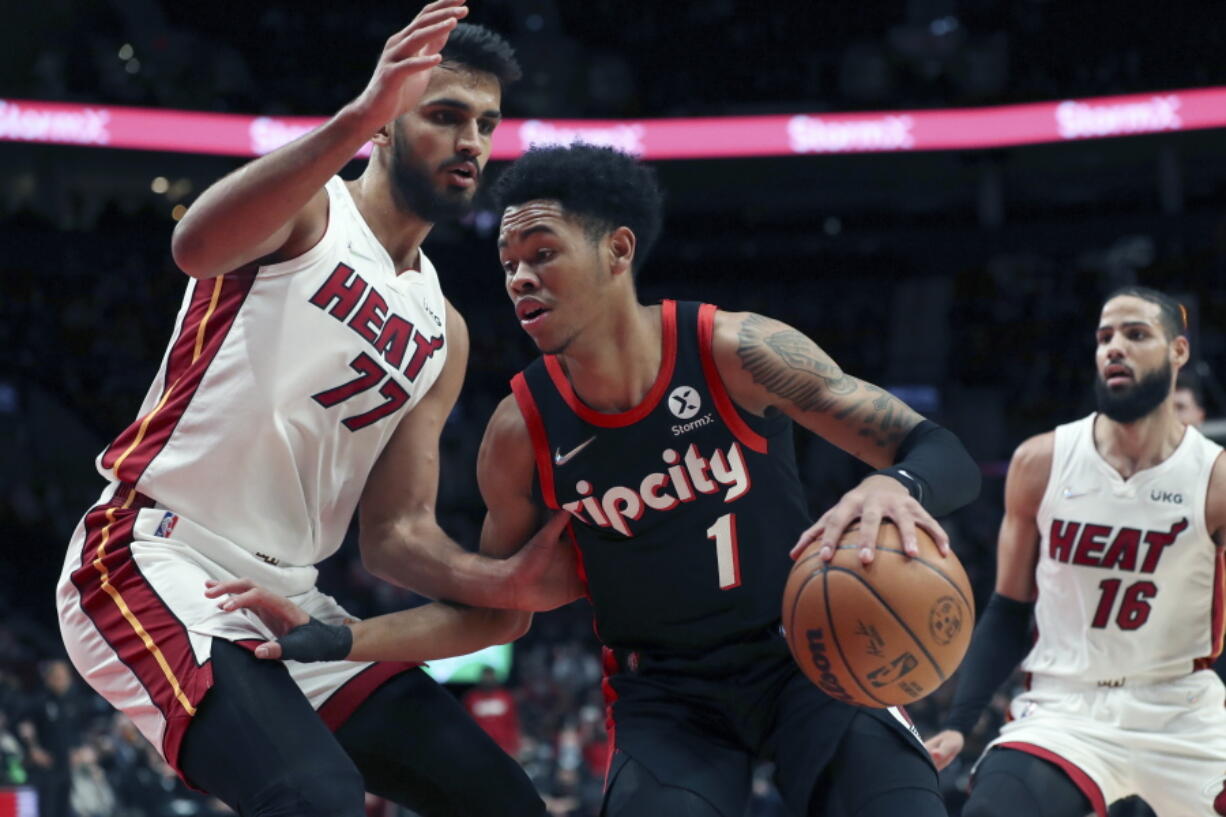 Portland Trail Blazers guard Anfernee Simons drives past Miami Heat center Omer Yurtseven during the first half of an NBA basketball game in Portland, Ore., Wednesday, Jan. 5, 2022.